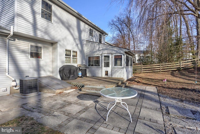 rear view of house with a patio area, fence, a wooden deck, and central AC unit