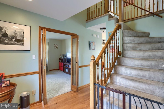 stairs with baseboards and wood finished floors