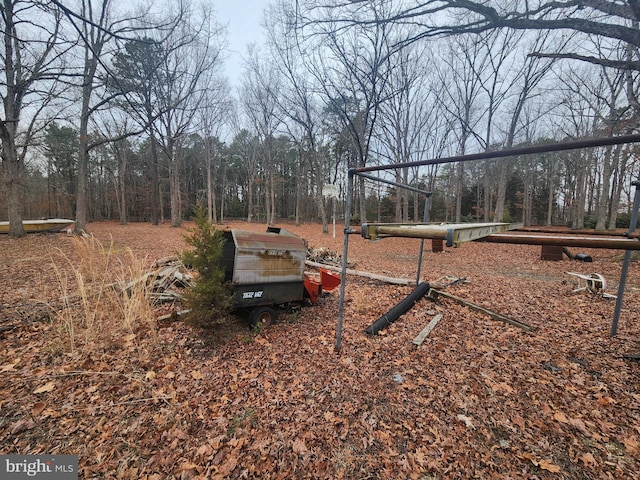 view of yard with a view of trees