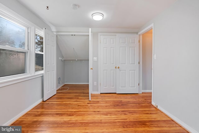 unfurnished bedroom featuring light wood-style flooring and baseboards