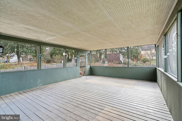 unfurnished sunroom with wood ceiling and plenty of natural light