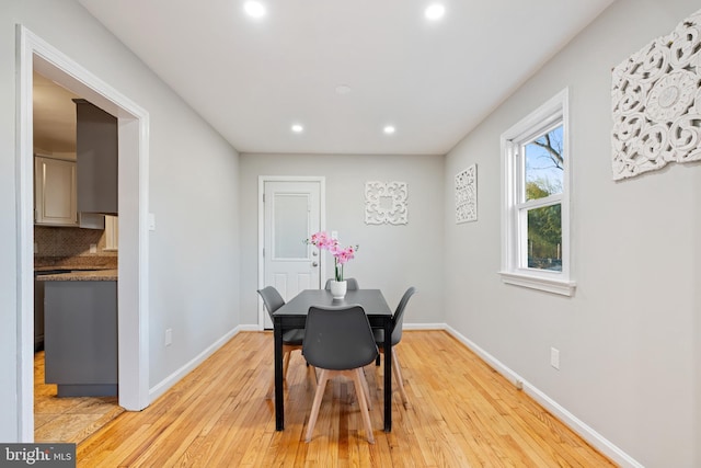 dining space featuring recessed lighting, baseboards, and light wood finished floors