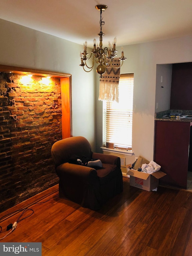 sitting room with wood-type flooring and a notable chandelier