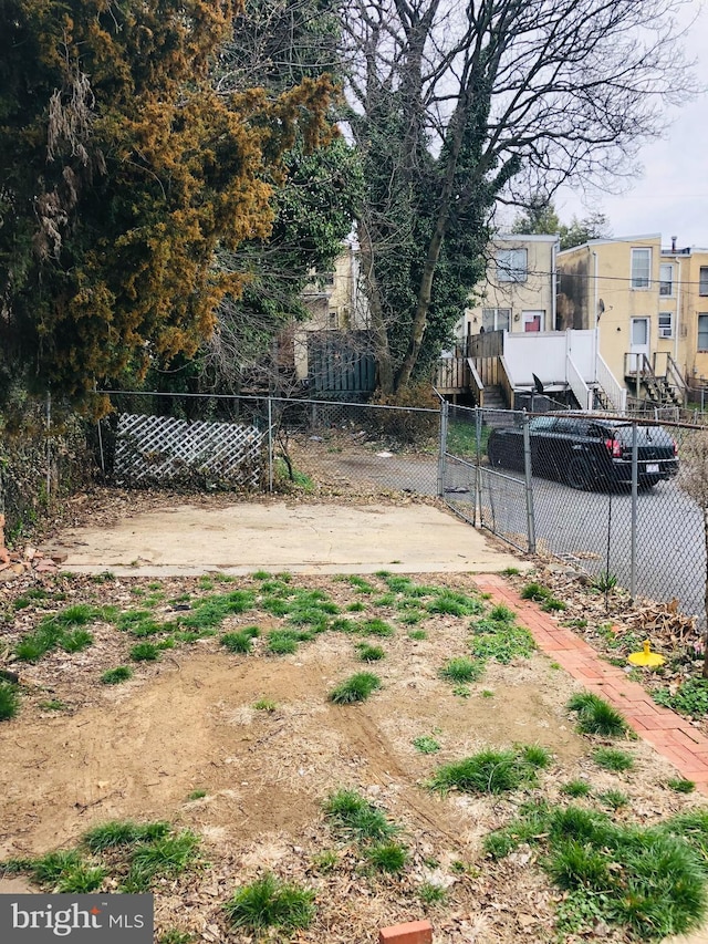 view of yard featuring fence private yard, a gate, and stairway