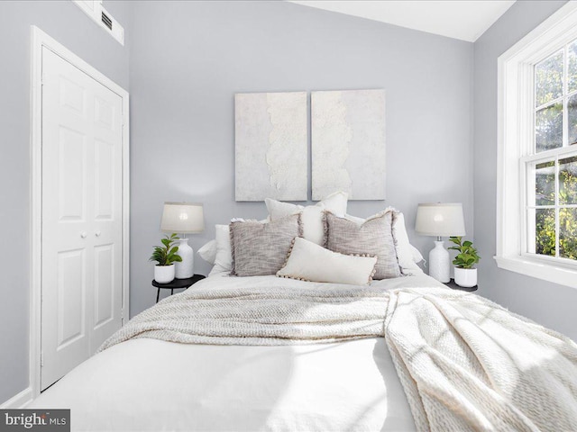 bedroom featuring multiple windows and visible vents