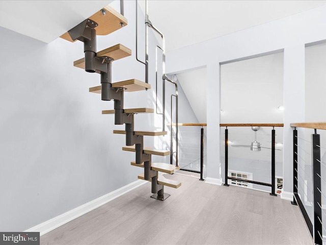 stairs with baseboards and wood finished floors