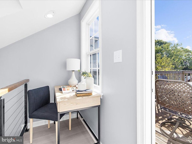 office space featuring baseboards, wood finished floors, and a healthy amount of sunlight