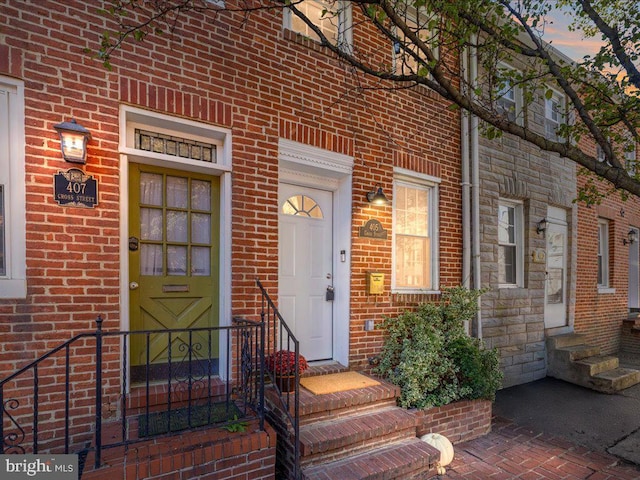 property entrance with brick siding