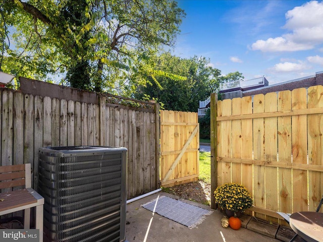 view of patio / terrace featuring central AC unit and fence