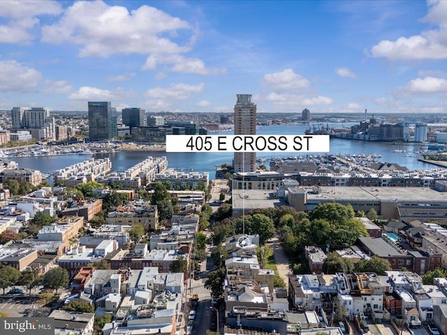 birds eye view of property featuring a water view and a city view