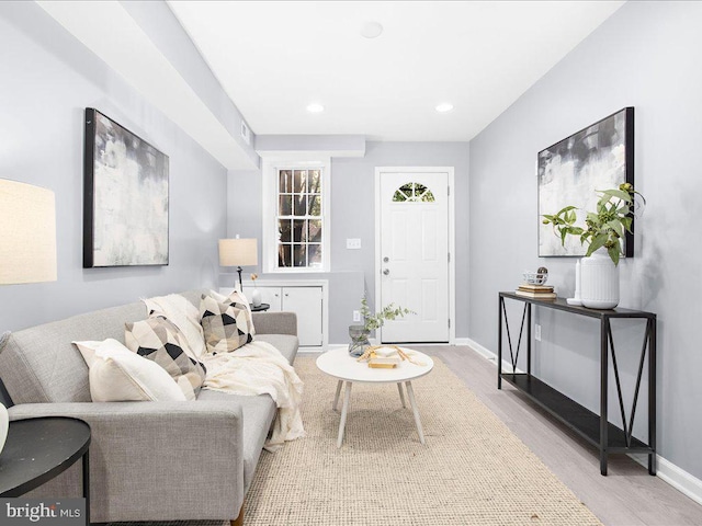 living area with visible vents, baseboards, wood finished floors, and recessed lighting