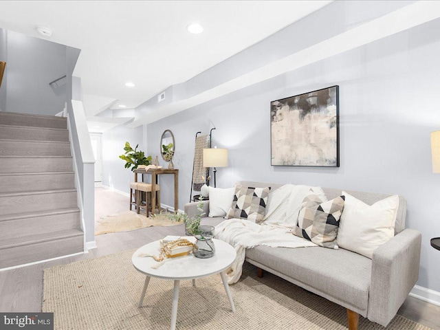 living area featuring recessed lighting, stairway, baseboards, and wood finished floors