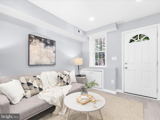 living area featuring recessed lighting, visible vents, baseboards, and wood finished floors