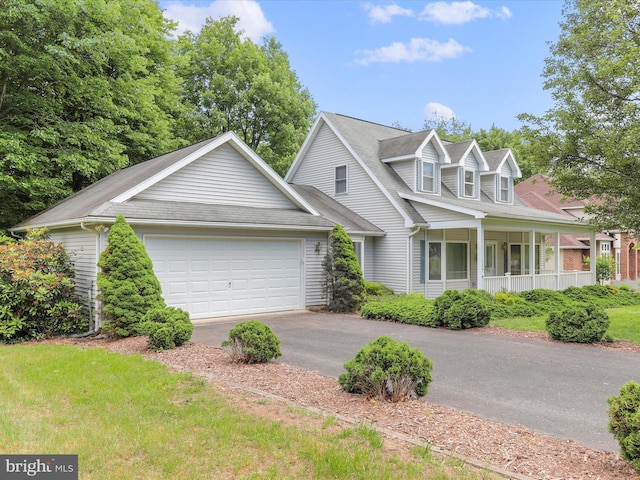 cape cod house featuring a garage and aphalt driveway