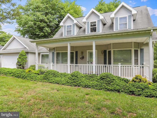 cape cod-style house featuring a garage, covered porch, and a front lawn