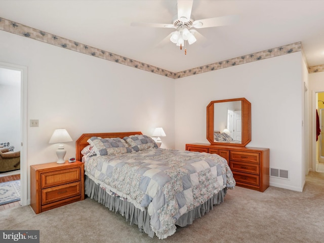 carpeted bedroom with visible vents and ceiling fan