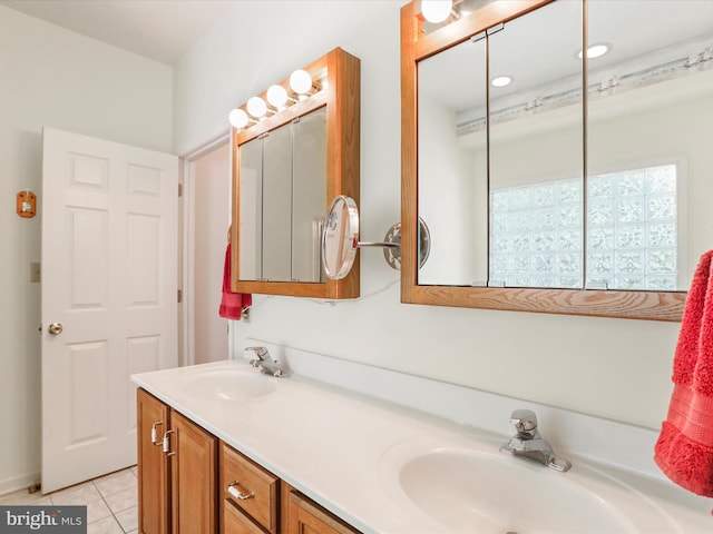 bathroom with double vanity, a sink, and tile patterned floors