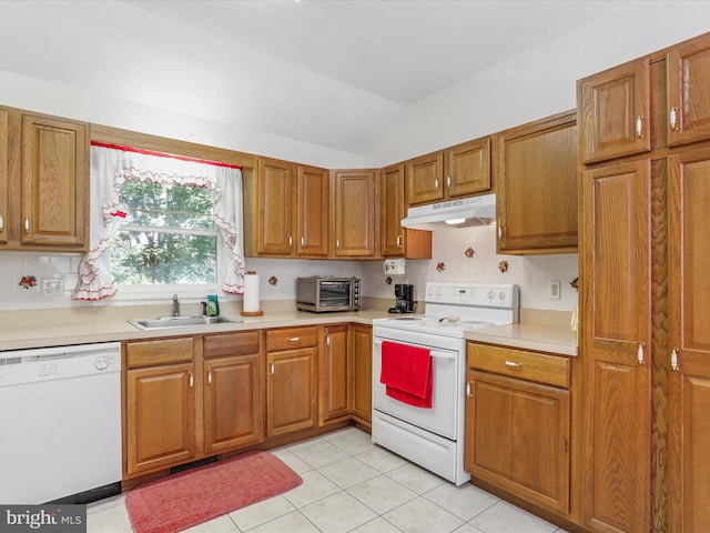 kitchen featuring light countertops, brown cabinetry, a sink, white appliances, and under cabinet range hood