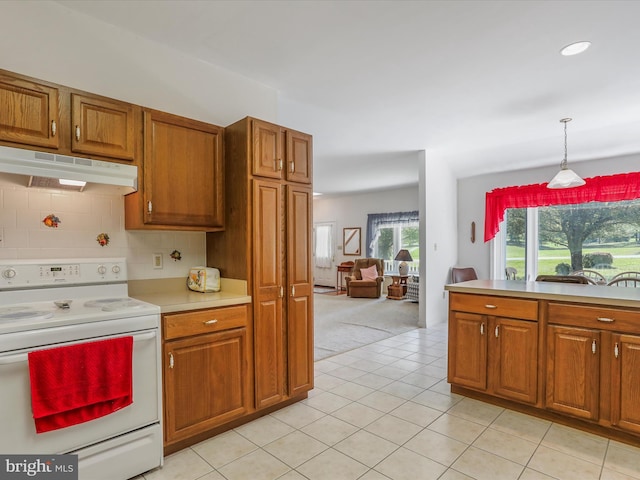 kitchen featuring electric stove, brown cabinets, light countertops, and under cabinet range hood