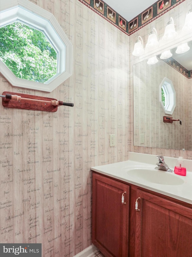 bathroom featuring wallpapered walls and vanity