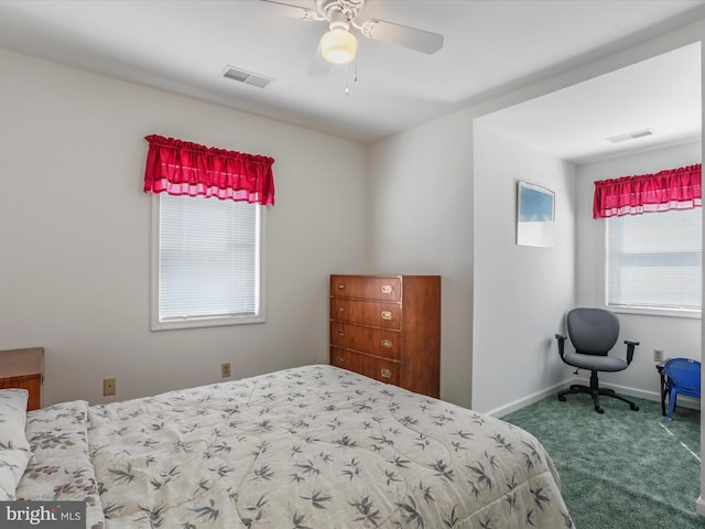 carpeted bedroom with a ceiling fan, visible vents, and baseboards