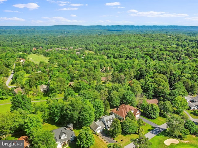 drone / aerial view featuring a forest view