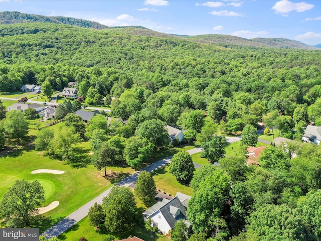 birds eye view of property featuring a mountain view and a wooded view