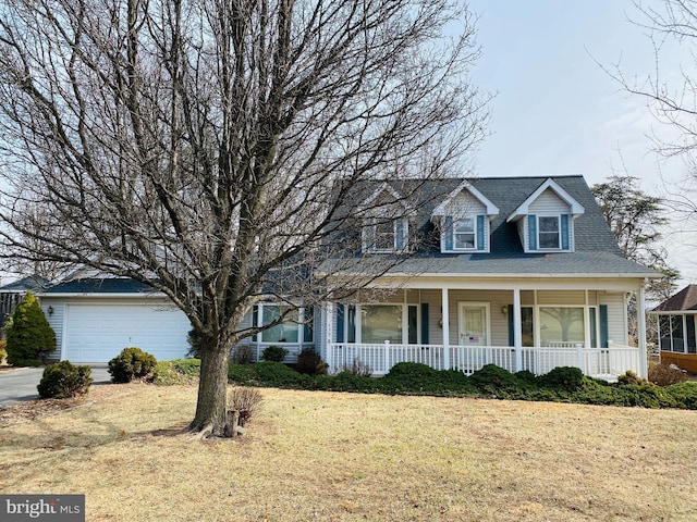 cape cod house with a garage, covered porch, a shingled roof, and a front yard