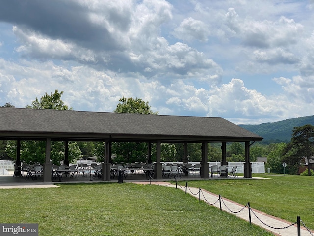 surrounding community featuring a lawn and a mountain view