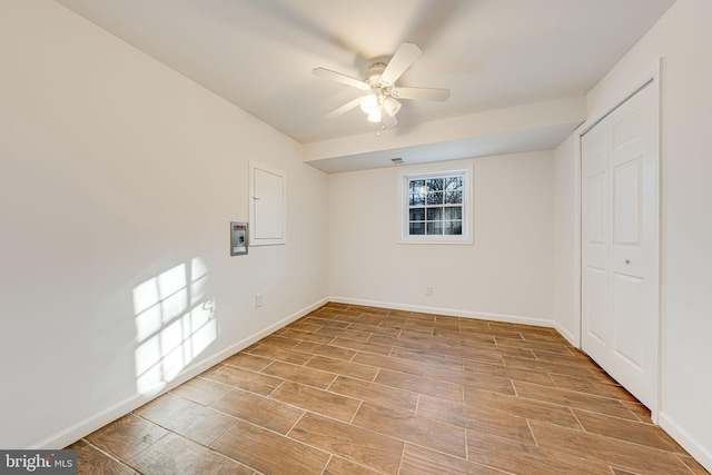 unfurnished bedroom with wood tiled floor, electric panel, and baseboards