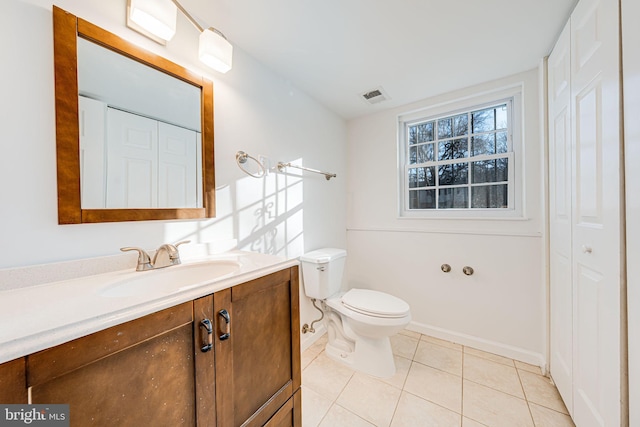 bathroom featuring a closet, visible vents, toilet, and tile patterned floors