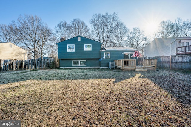 rear view of property with a deck, a yard, fence private yard, and central air condition unit