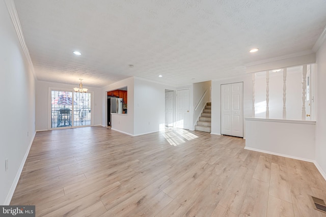 unfurnished living room with stairway, light wood-style flooring, visible vents, and crown molding