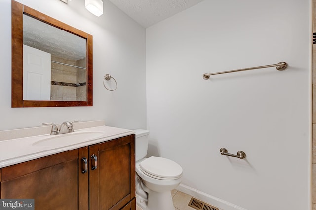 full bathroom with a textured ceiling, toilet, vanity, visible vents, and tile patterned floors