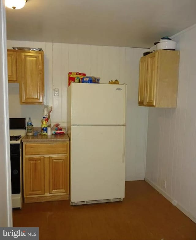 kitchen with range with electric cooktop and freestanding refrigerator