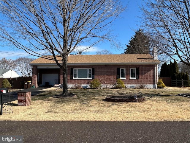 single story home with brick siding, a shingled roof, a garage, and fence