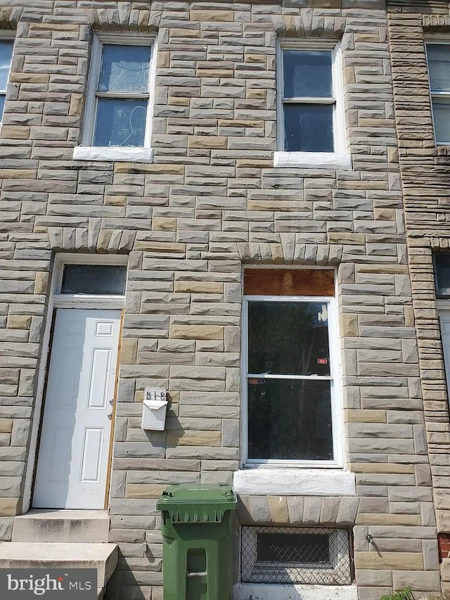 view of side of home with stone siding