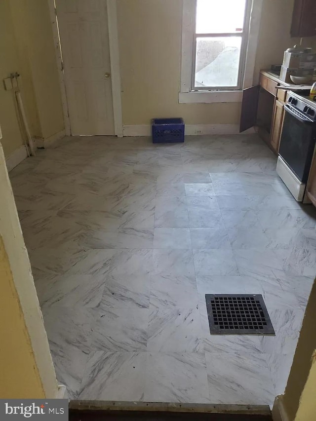 kitchen with visible vents, marble finish floor, range, and baseboards