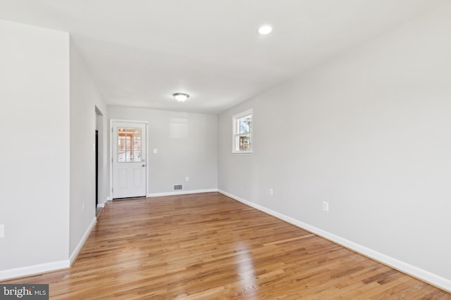 interior space featuring recessed lighting, visible vents, baseboards, and light wood finished floors