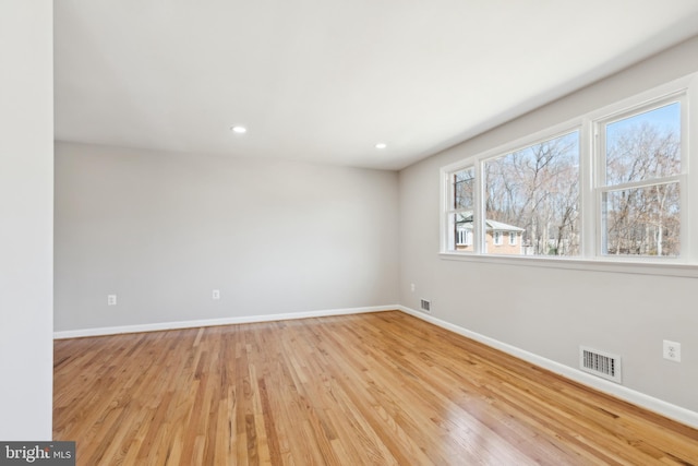 spare room featuring recessed lighting, baseboards, visible vents, and light wood finished floors