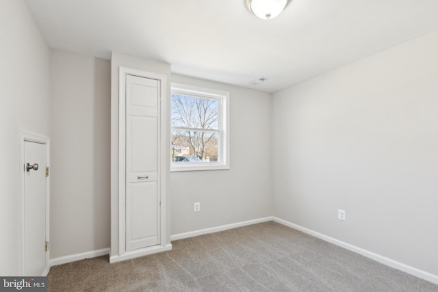 unfurnished bedroom with visible vents, baseboards, and carpet