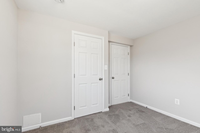 unfurnished bedroom with baseboards and carpet floors