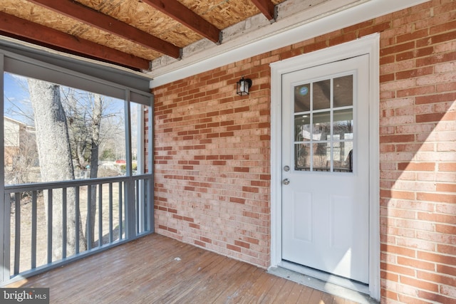 view of exterior entry featuring a porch