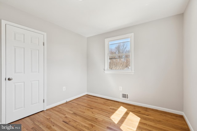 unfurnished bedroom featuring baseboards, visible vents, and light wood-type flooring