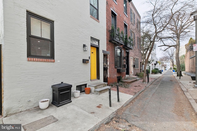 exterior space with brick siding and a residential view