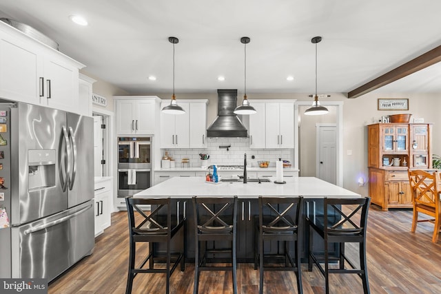 kitchen featuring appliances with stainless steel finishes, light countertops, custom range hood, and backsplash