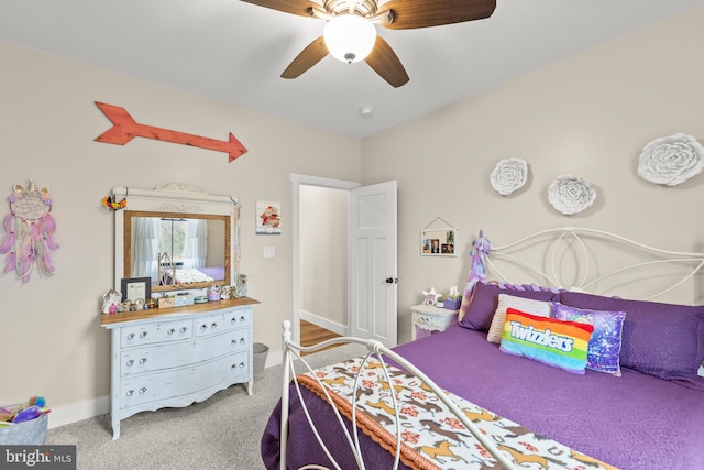 carpeted bedroom with a ceiling fan and baseboards