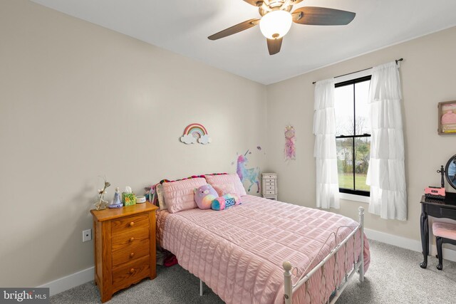 bedroom with multiple windows, carpet, a ceiling fan, and baseboards