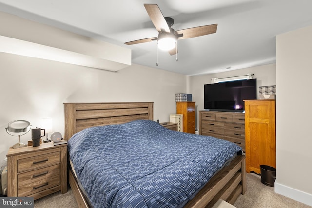 carpeted bedroom featuring ceiling fan and baseboards