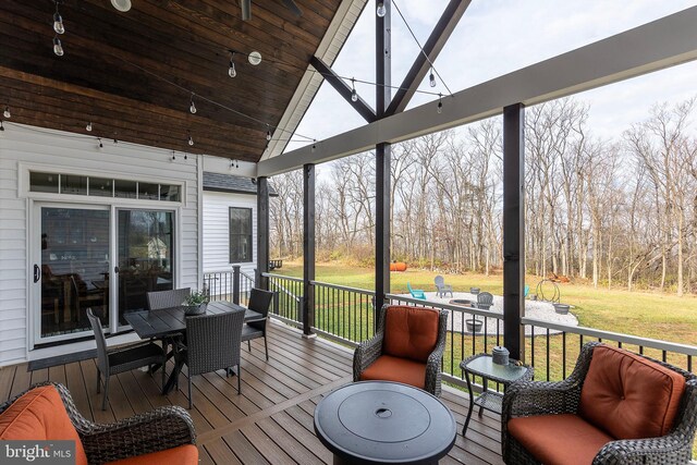 sunroom featuring lofted ceiling and a wealth of natural light